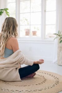 Woman meditating to reduce stress and improve immunity naturally